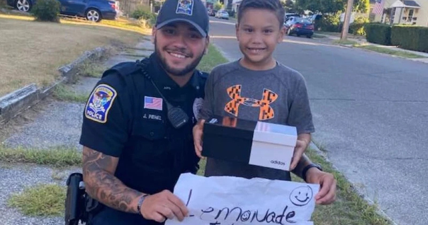 Police officer surprises 7-year-old boy selling lemonade with a pair of brand new sneakers for school