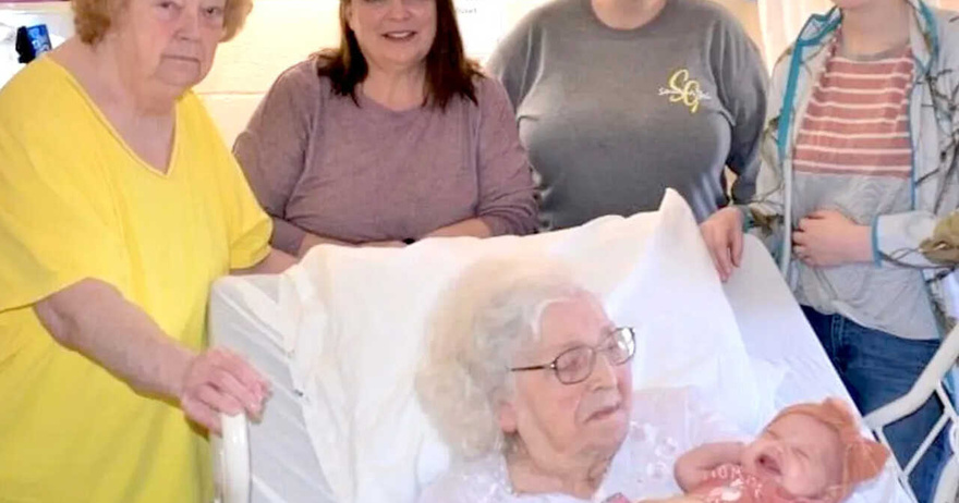 98-year-old woman poses for photo with 6 generations in it.